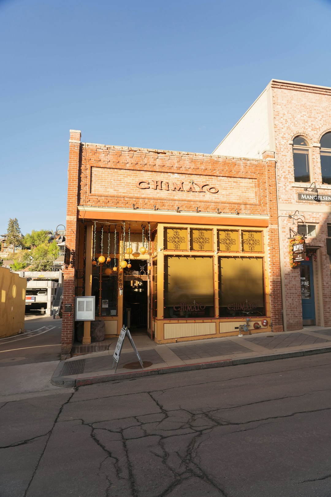 a-brick-building-with-chimayo-above-the-entrance-gfsfk2ar1qk